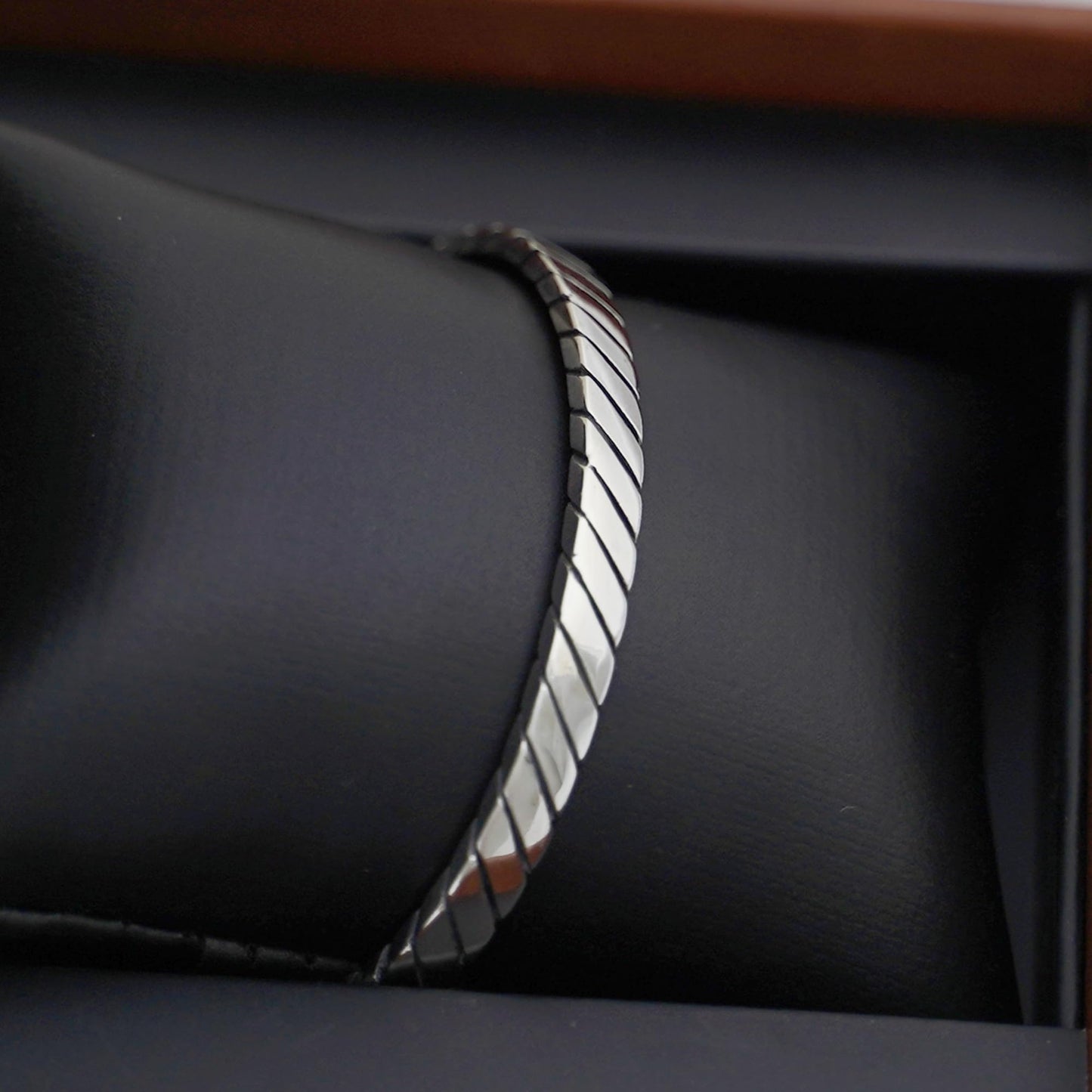 Oxidised rope cuff bangle side profile, twisted rope ridges and dark oxidised edges