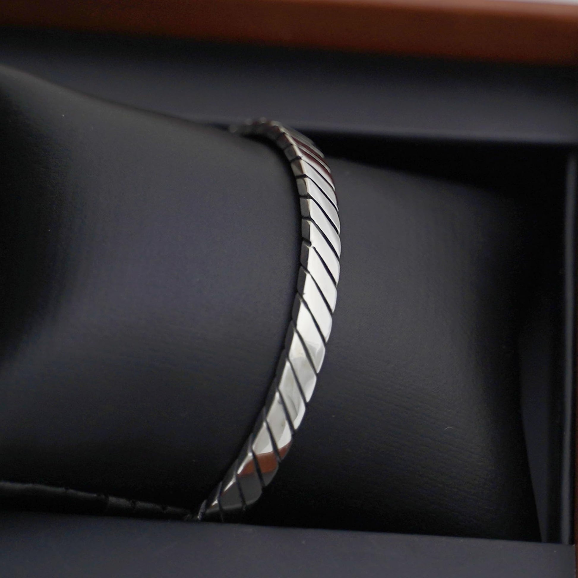 Oxidised rope cuff bangle side profile, twisted rope ridges and dark oxidised edges