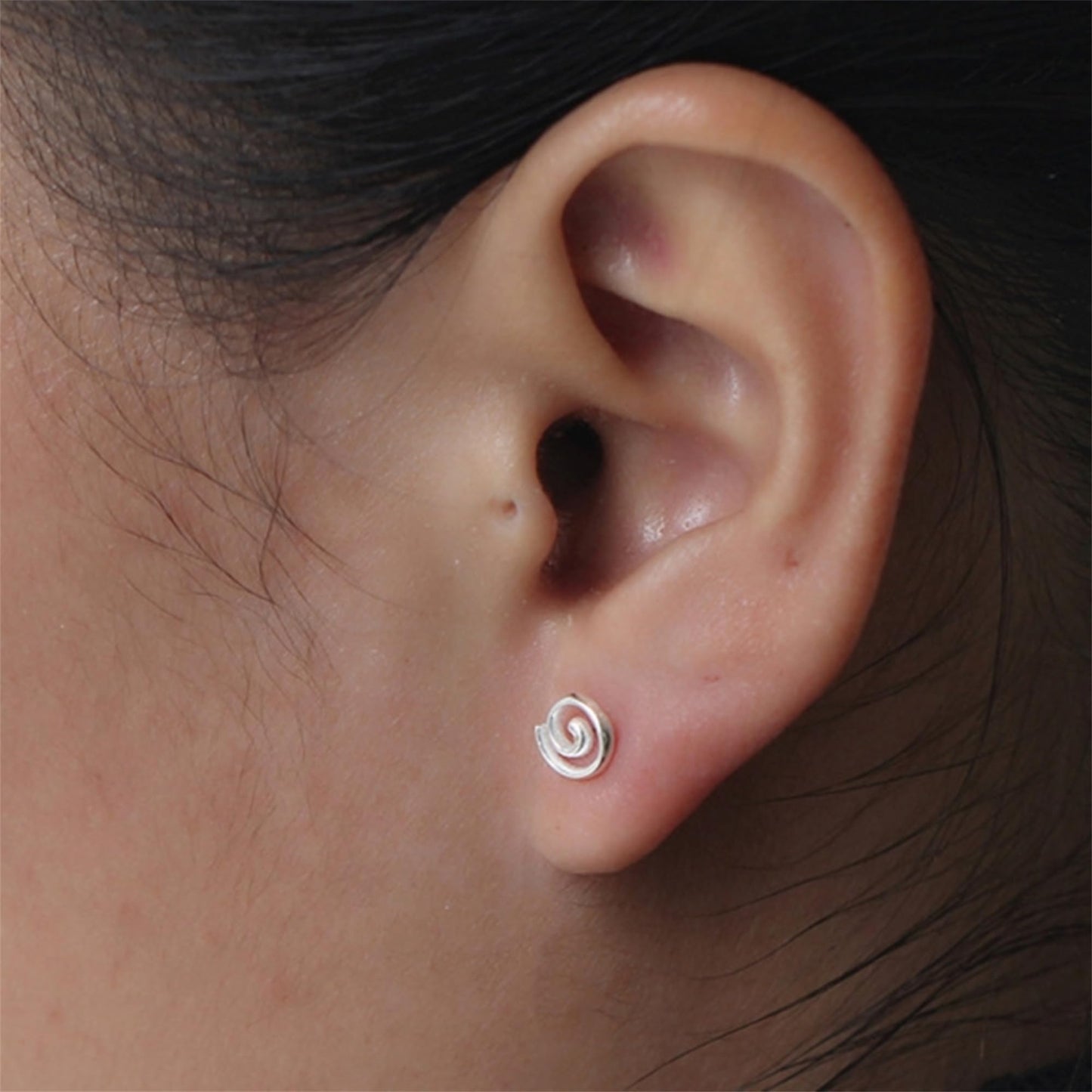 Spiral Swirl Studs worn on ear, small silver swirl spiral post earrings