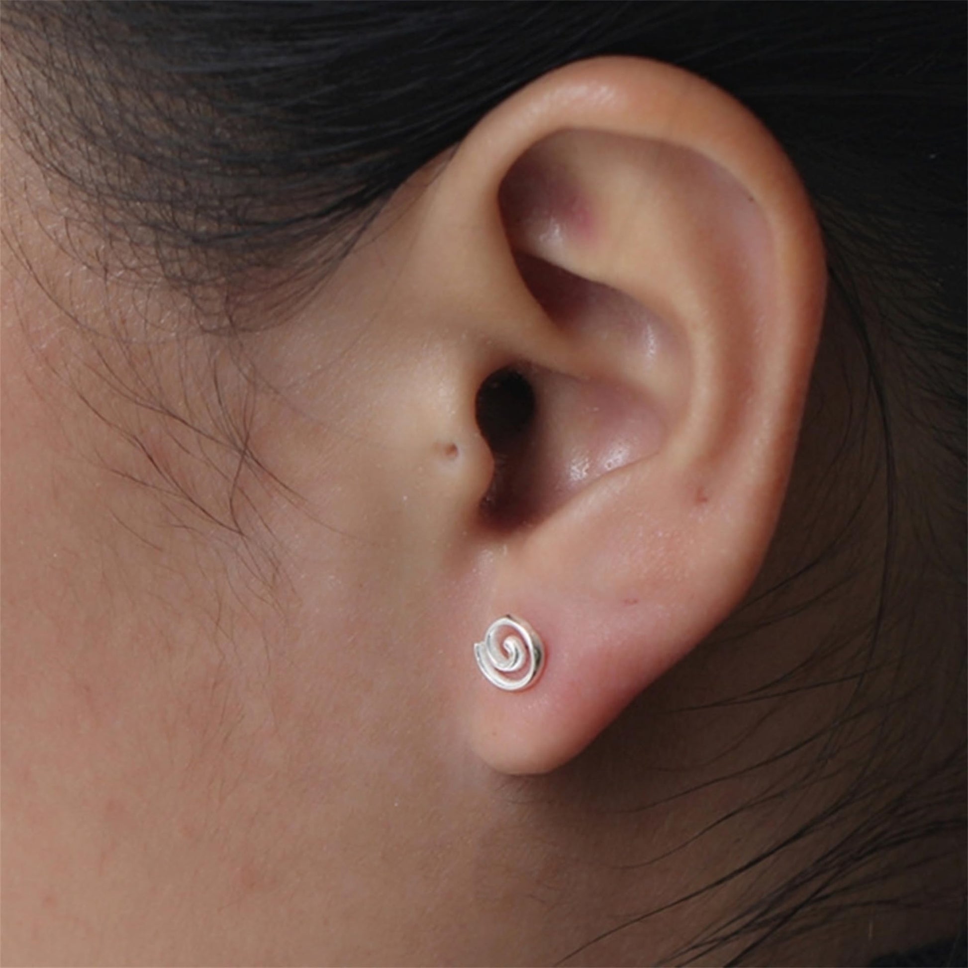 Spiral Swirl Studs worn on ear, small silver swirl spiral post earrings