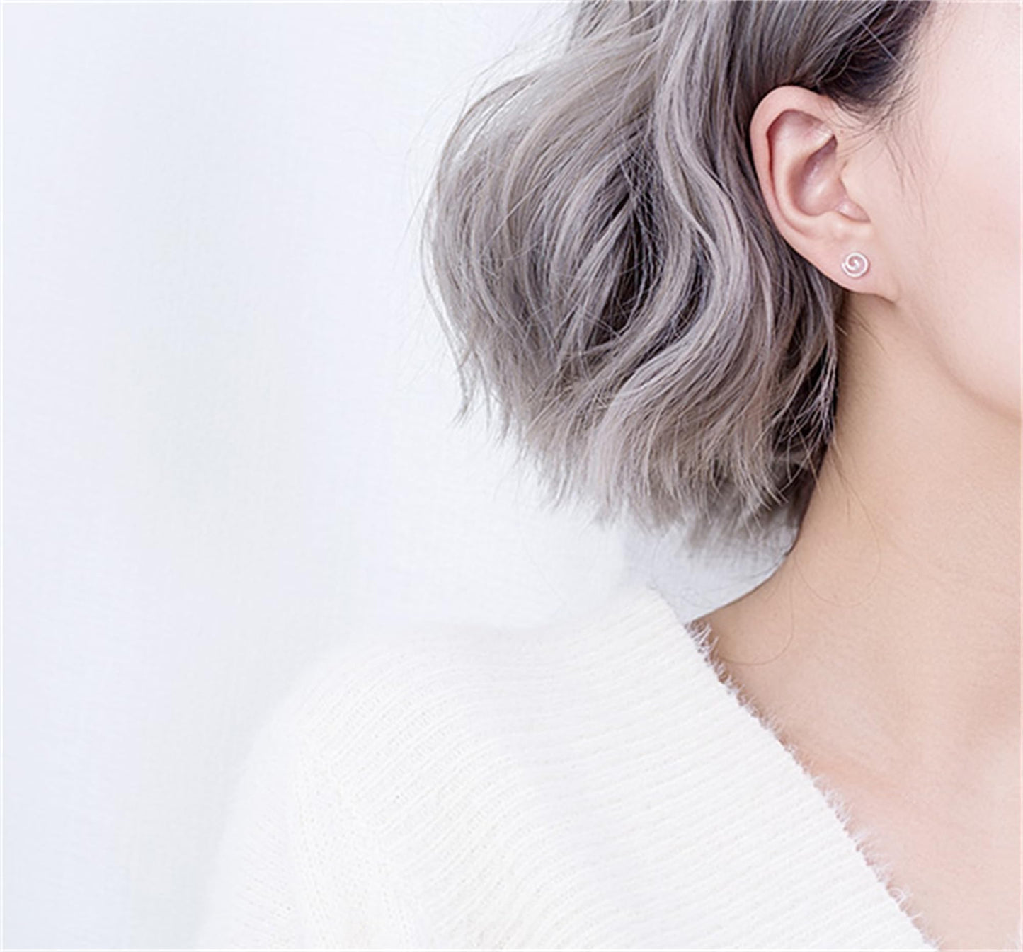 Spiral Swirl Studs on ear, subtle silver swirl stud earring visible