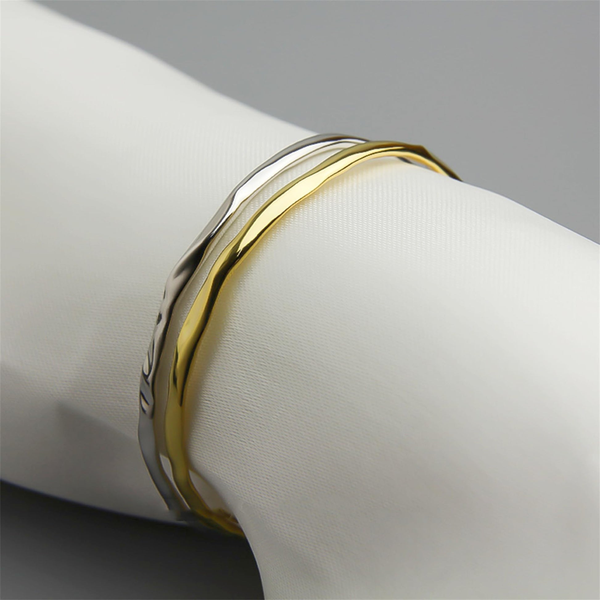 Hammered 18K gold cuff bracelet on wrist, curved open band