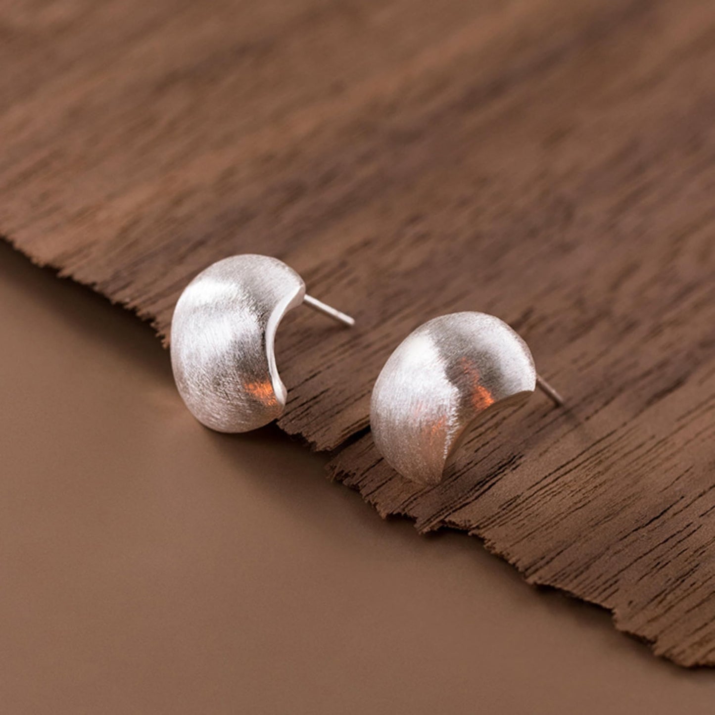 Brushed half-hoop drop earrings, close view of pin post backs, silver
