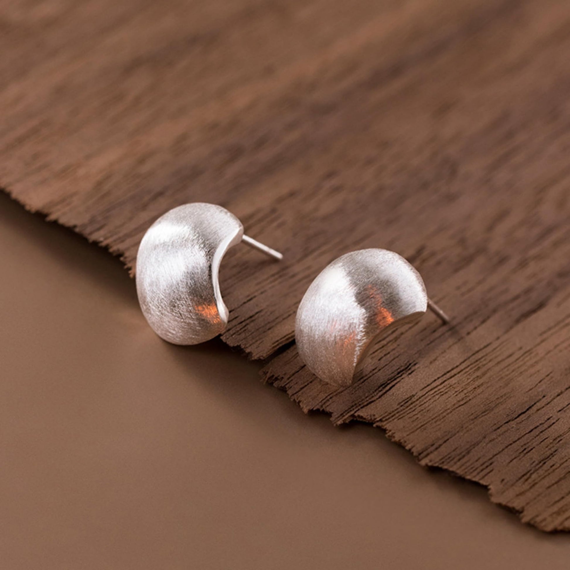 Brushed half-hoop drop earrings, close view of pin post backs, silver