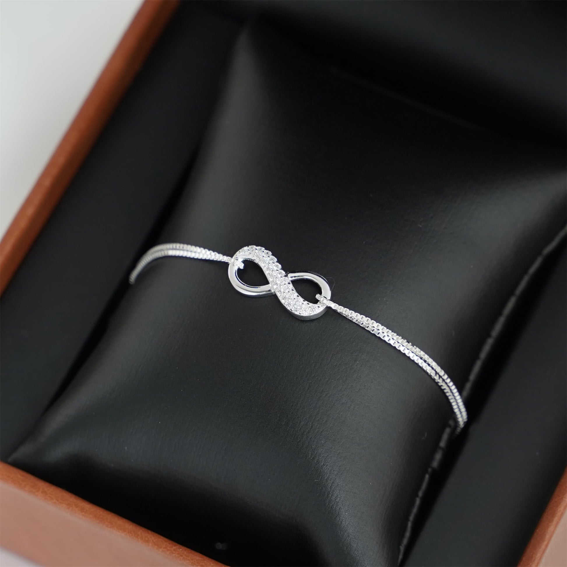 CZ Infinity bracelet: textured infinity loops with small oval bezel accents