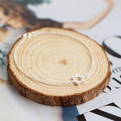 Silver Star of David bracelet with star charm on a delicate bead-like chain.