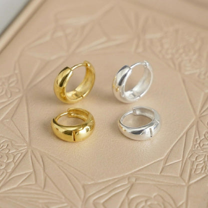 Teardrop hoop huggie earrings: gold and silver pair, front-facing profiles