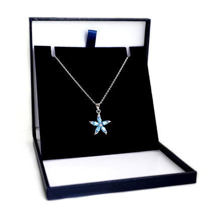 Rhodium curb chain necklace with blue star flower pendant