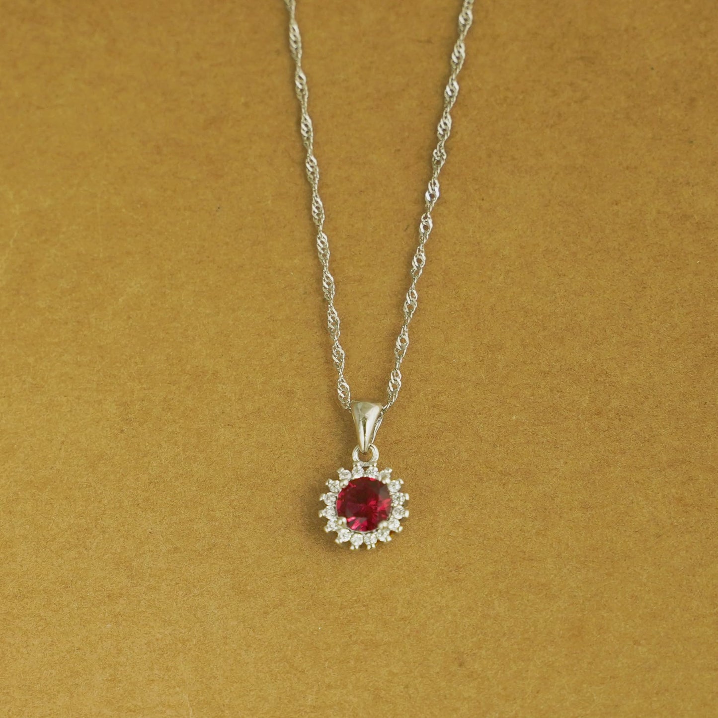 Rhodium twisted chain with red gemstone flower halo pendant
