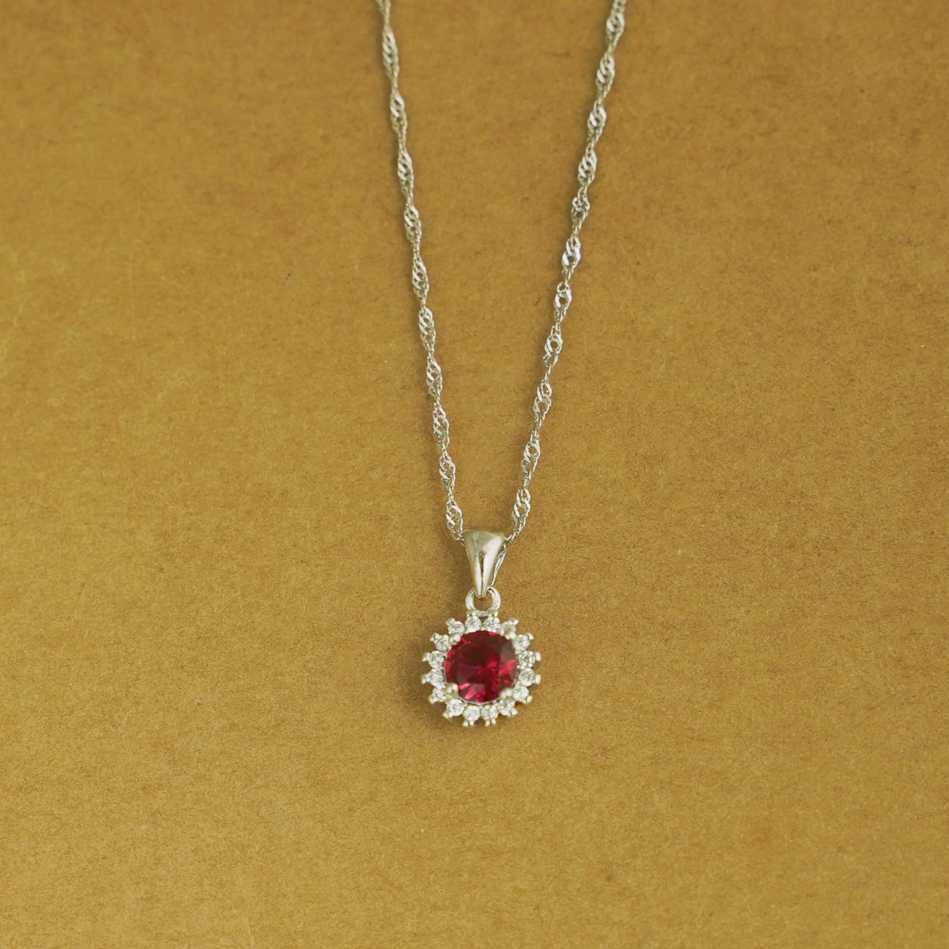 Rhodium twisted chain with red gemstone flower halo pendant