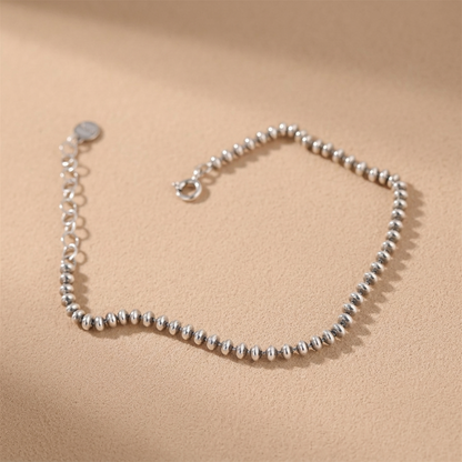 Oxidised flat bead bracelet close-up of silver-toned round beaded chain