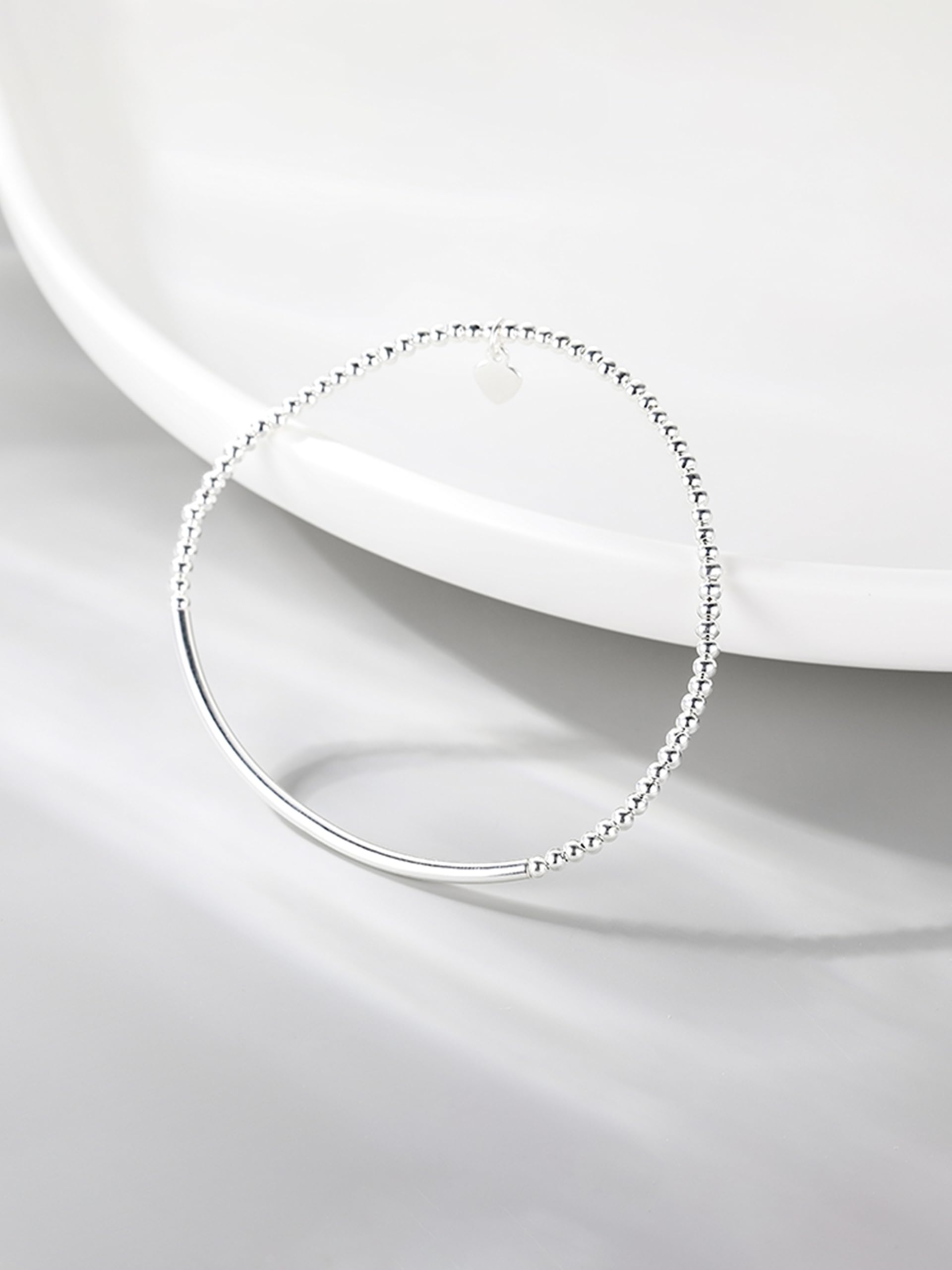 Silver heart charm stretch bracelet with beaded links and smooth curved bar