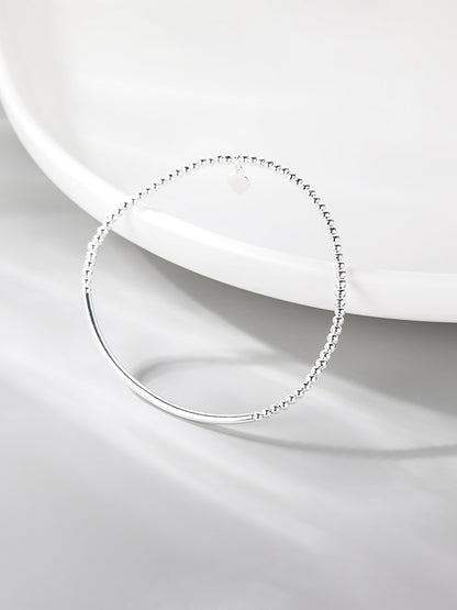 Silver heart charm stretch bracelet with beaded links and smooth curved bar