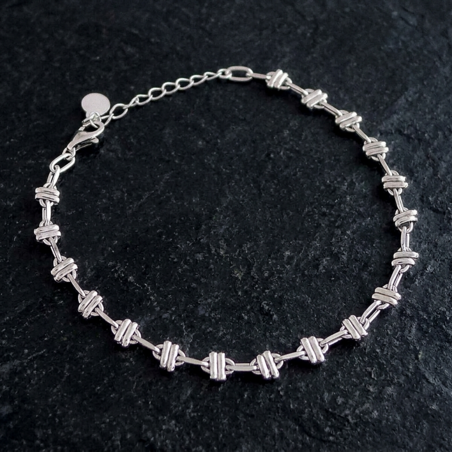 Oval rope curb bracelet with repeating oval link bars in silver-tone