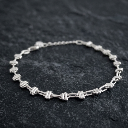 Close-up oval rope curb bracelet: oval link bars on silver-tone curb chain