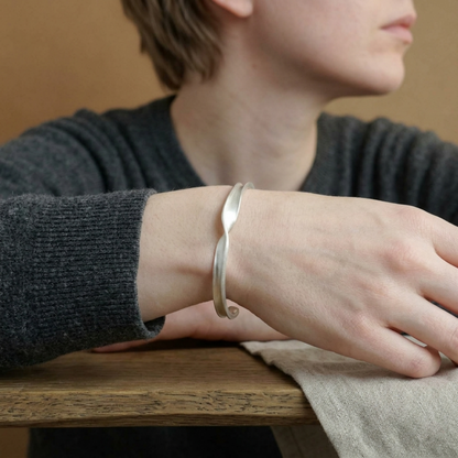 Matte Twist Rope Cuff bracelet on wrist, silver-tone matte twisted rope design