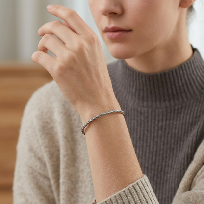 Snake knot cuff bangle on wrist, braided metal pattern open bracelet
