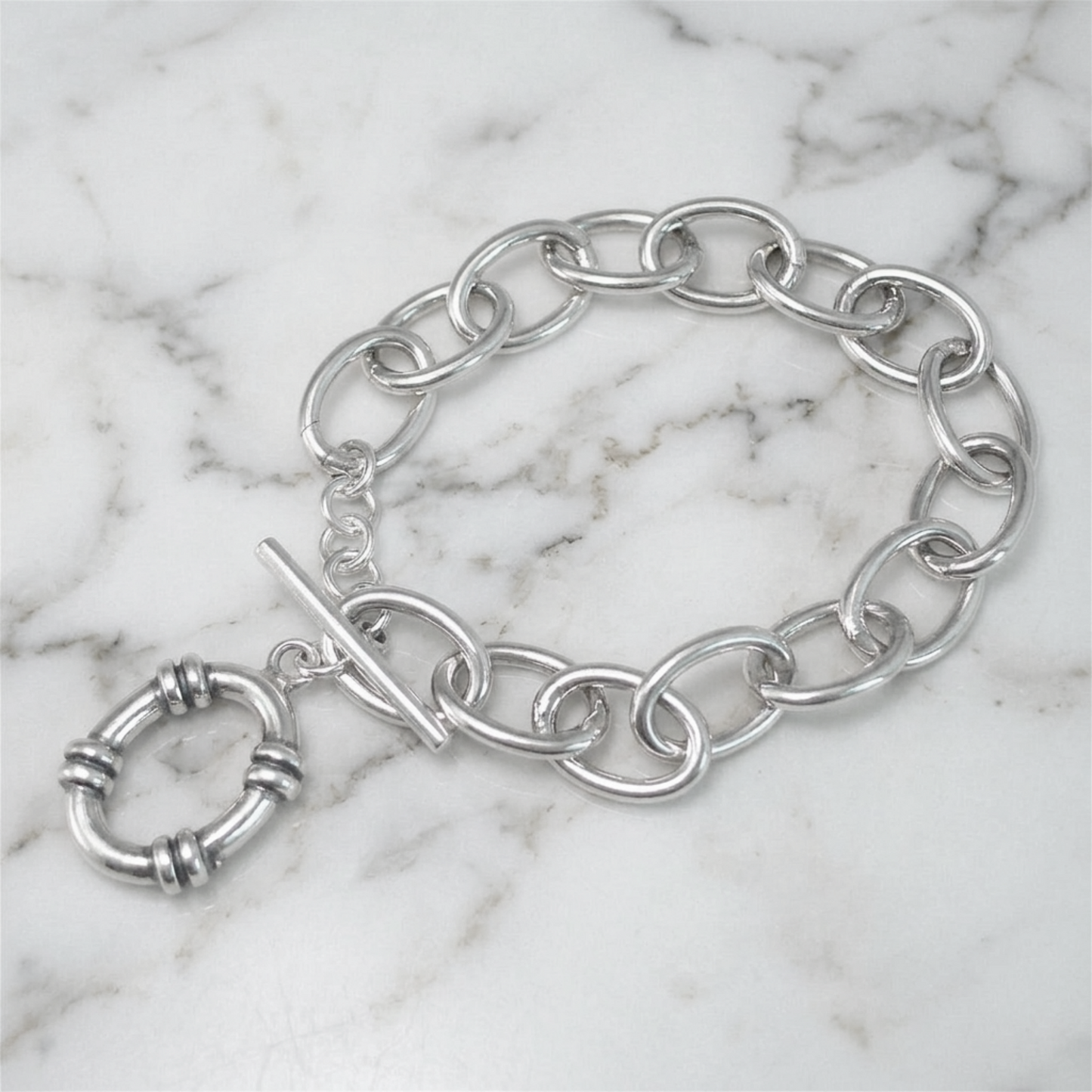 Oxidised linked T-bar bracelet on marble surface with hoop charm and oval links
