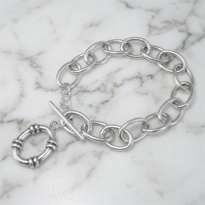 Oxidised linked T-bar bracelet on marble surface with hoop charm and oval links