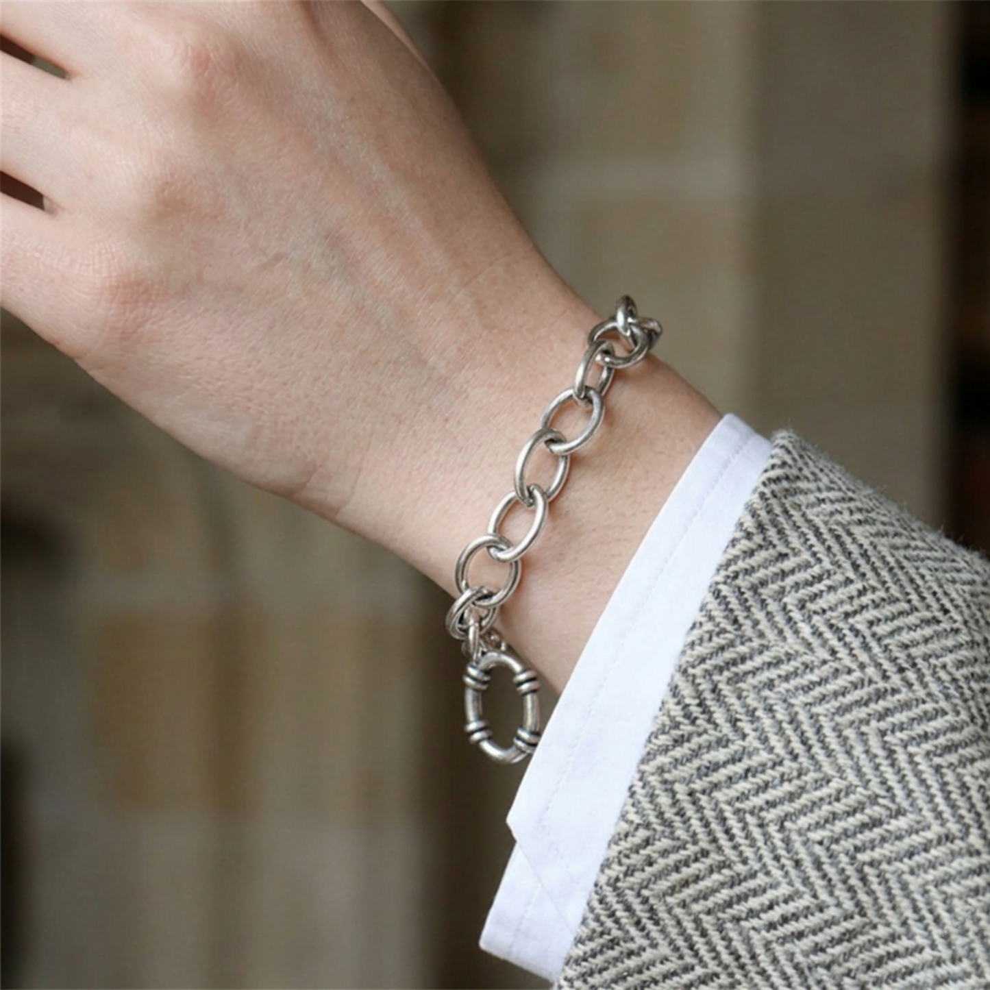 Oxidised T-bar bracelet on wrist with oval chain links and hoop charm