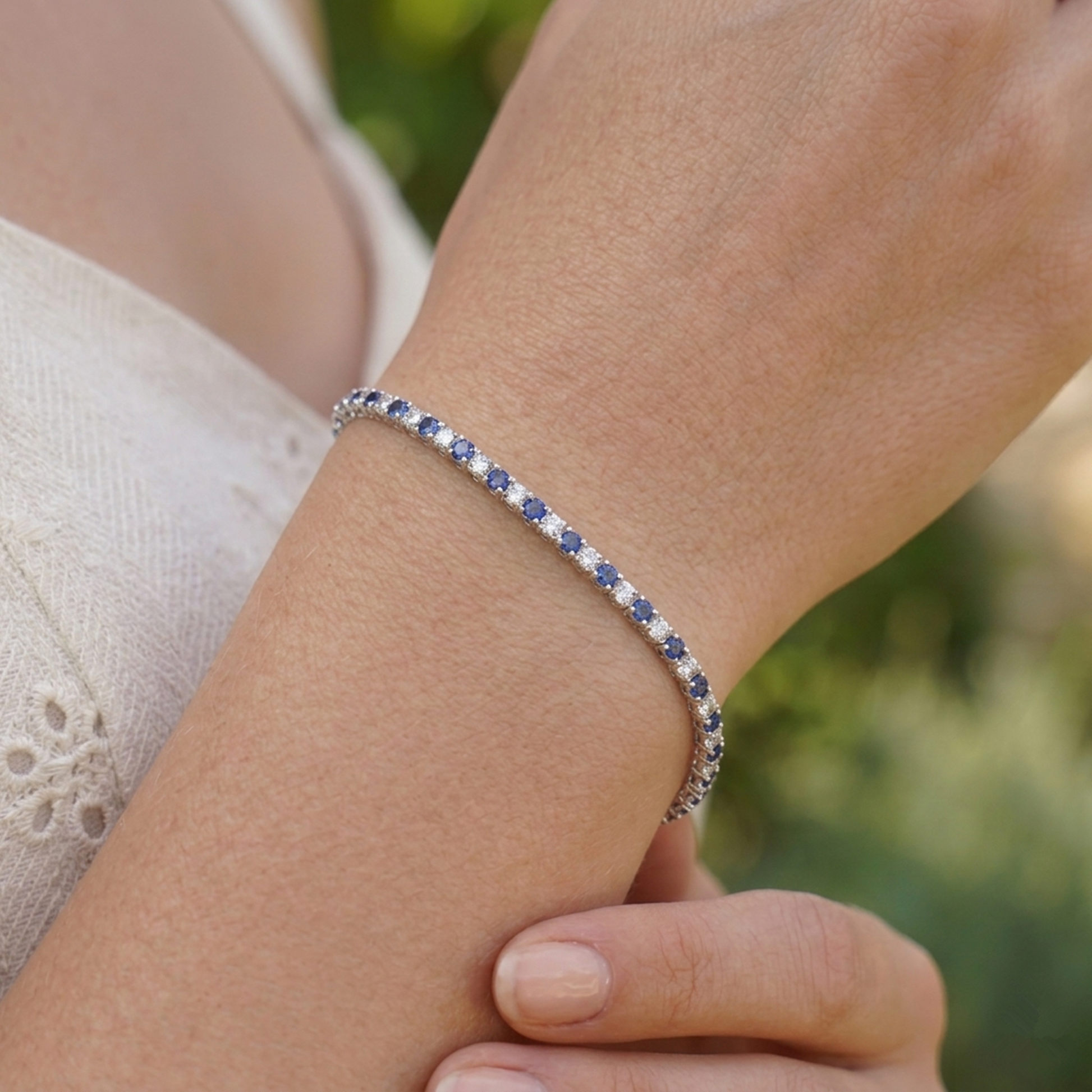 Sapphire tennis bracelet with blue stones in a row and slim metal band