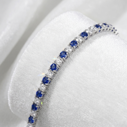 Close-up of sapphire tennis bracelet links with blue stones and clear side accents