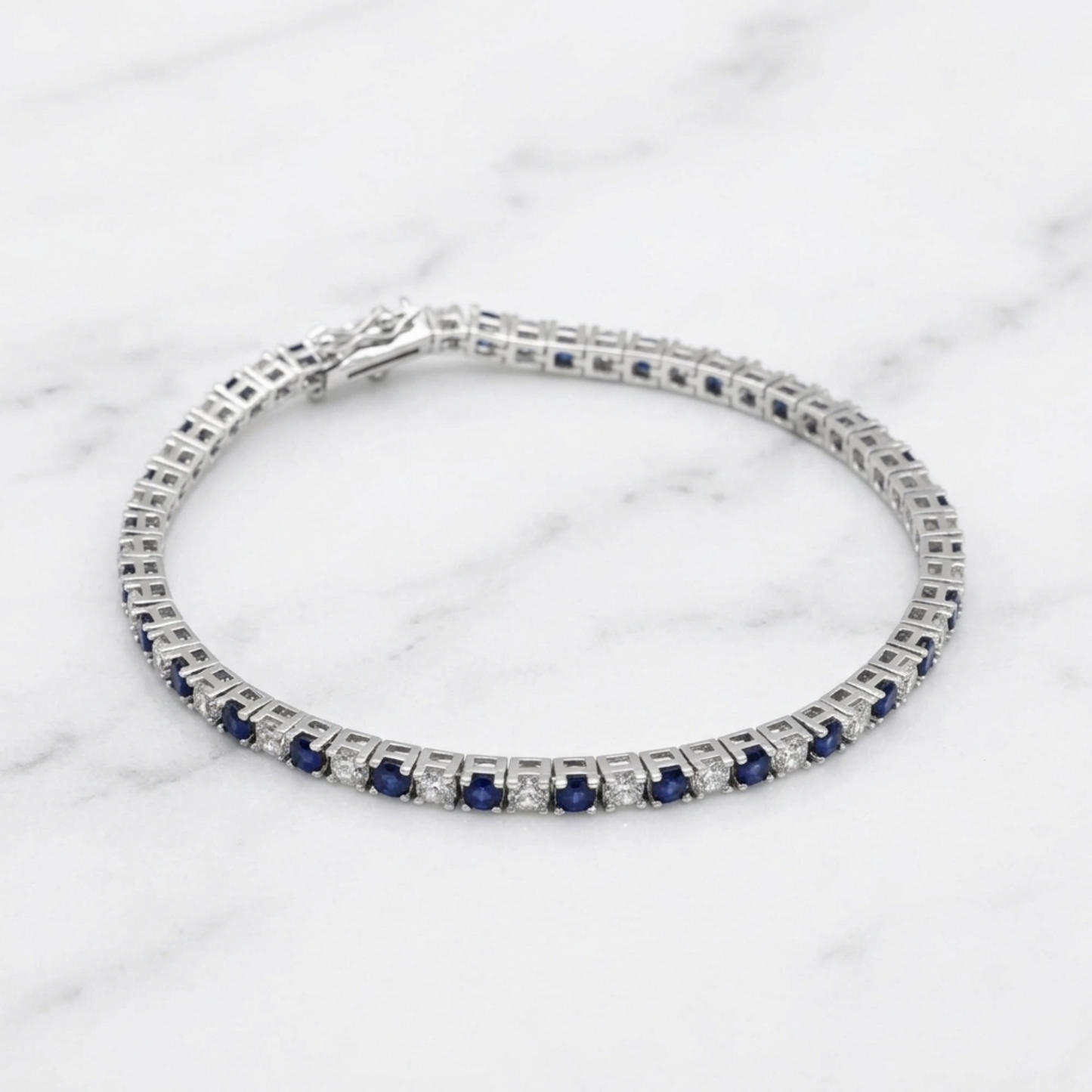 Sapphire tennis bracelet bracelet stack view with blue stones and clear diamond accents