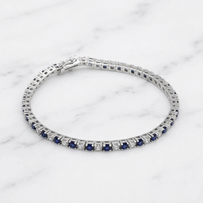 Sapphire tennis bracelet bracelet stack view with blue stones and clear diamond accents