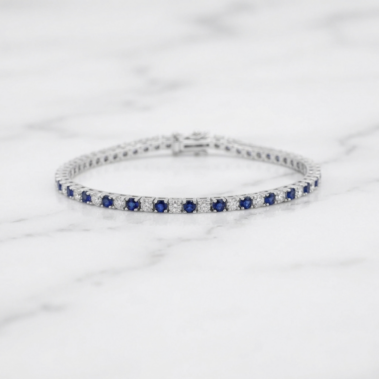 Sapphire tennis bracelet side profile showing blue stones in a line of settings