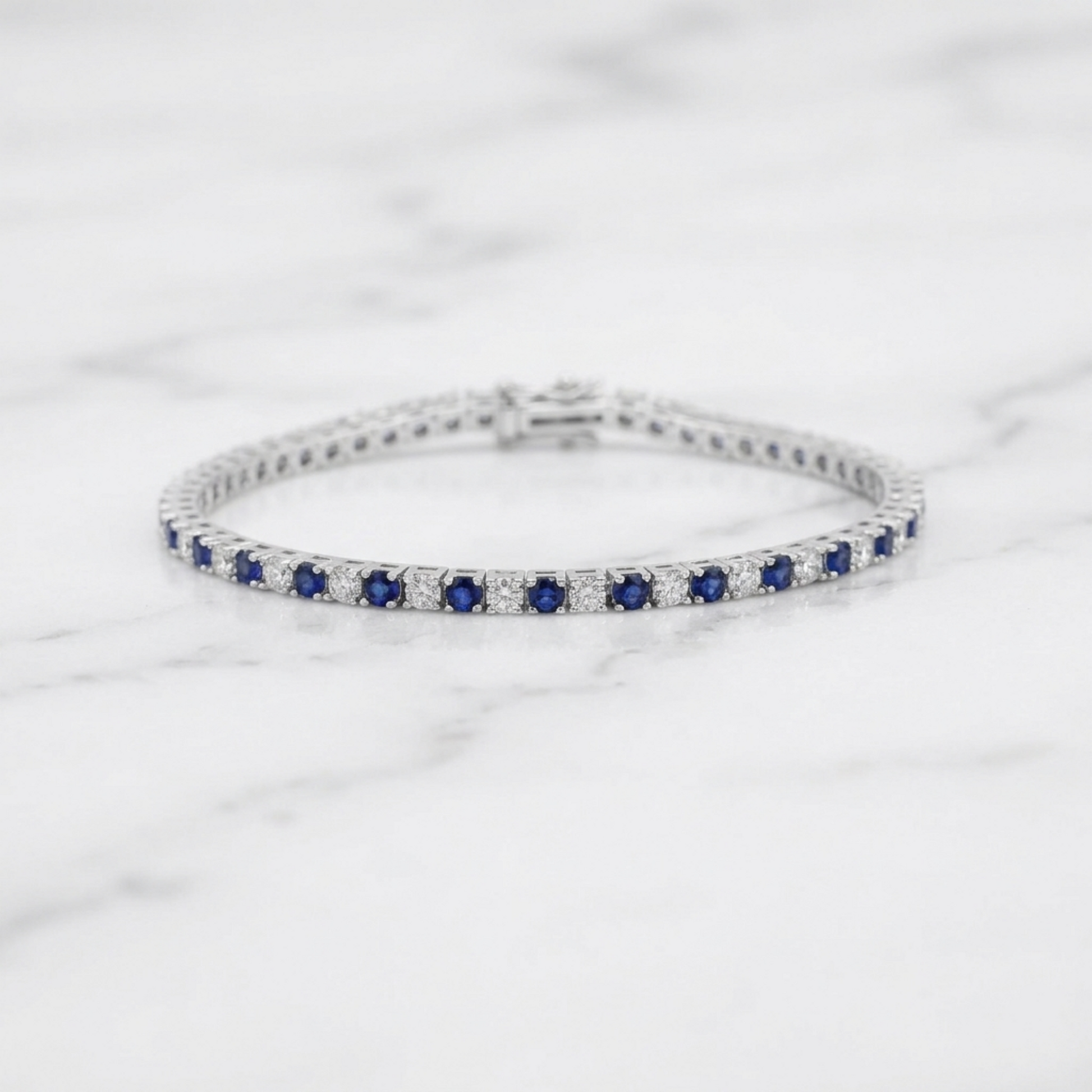 Sapphire tennis bracelet side profile showing blue stones in a line of settings