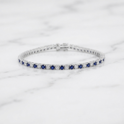 Sapphire tennis bracelet side profile showing blue stones in a line of settings