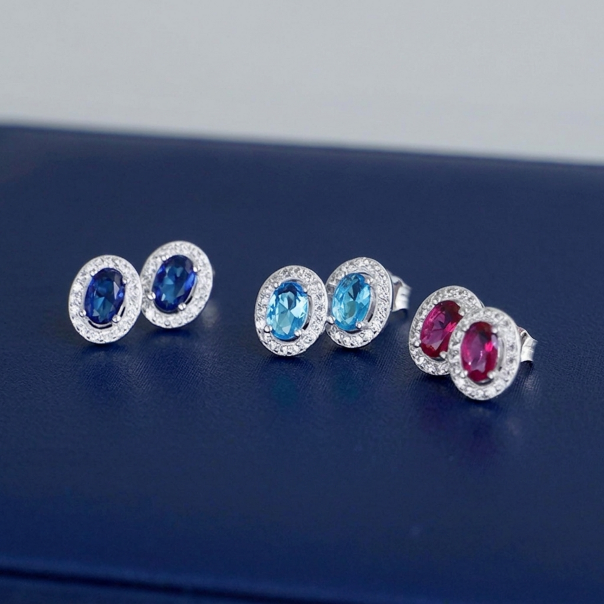 Multicolour CZ halo stud earrings: sapphire blue, aqua-blue and pink oval stones