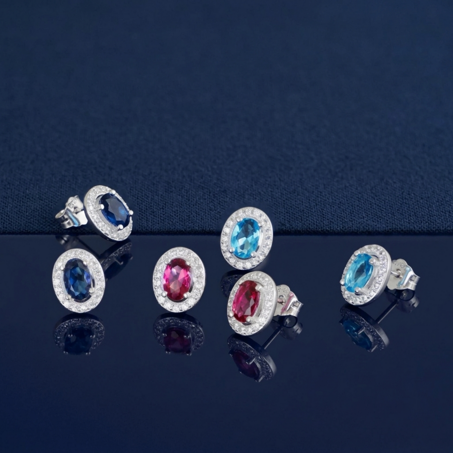 Silver-tone oval CZ halo stud earrings with blue and pink oval stones