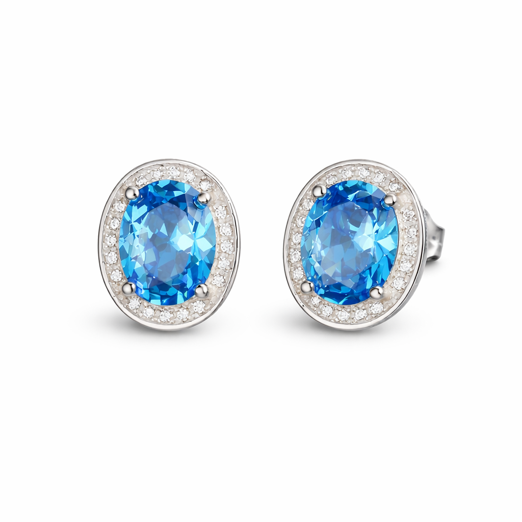 Blue topaz CZ halo studs: oval blue stone with clear pavé halo, silver-tone setting.