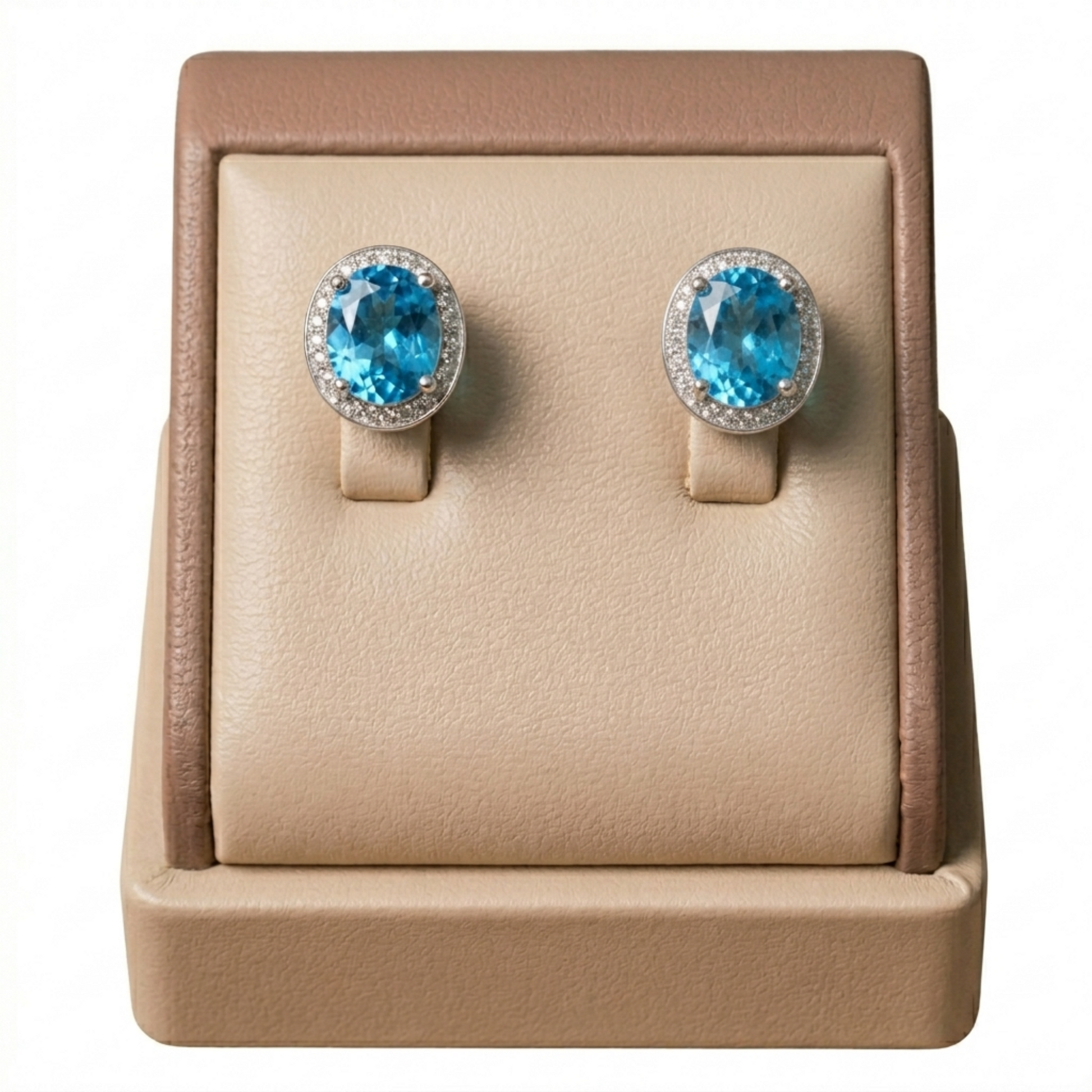 Blue topaz CZ halo studs: oval light-blue center stones with clear halo and prongs.