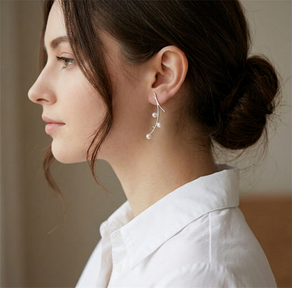 Pearl mistletoe drop earrings worn: curved wire with small dangling pearls
