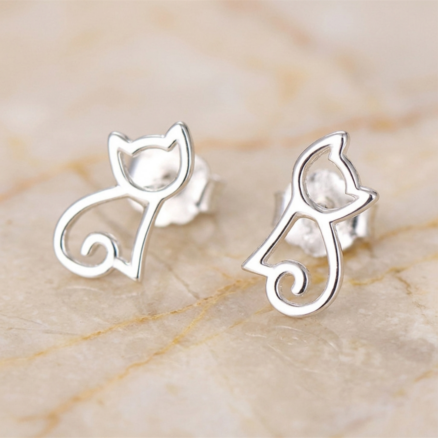 Cat outline stud earrings in polished silver, showing post backs