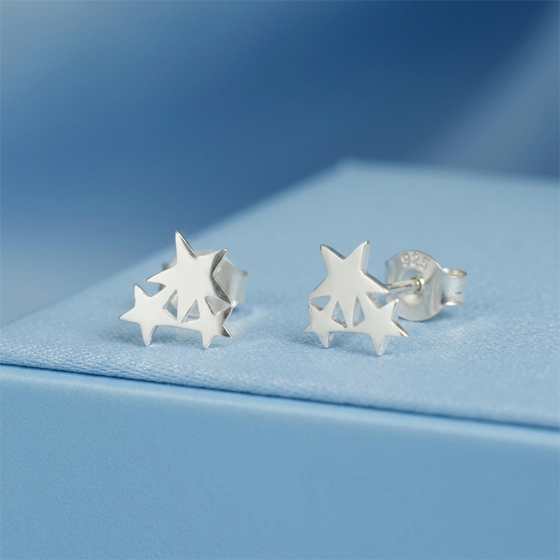 Triple Star stud earrings with one visible 925 stamped butterfly back