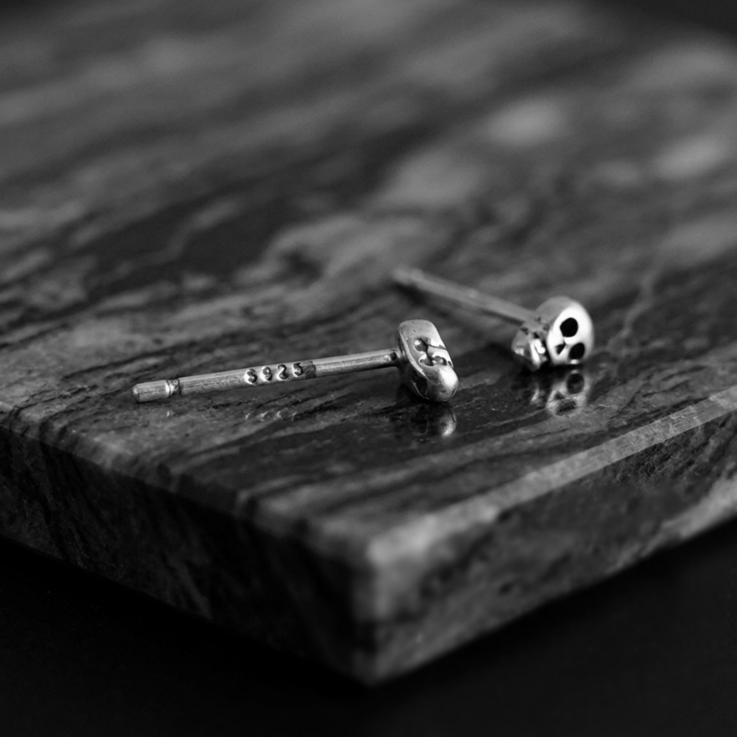Pair of mini skull stud earrings with black-eyed skulls and silver-tone backs/posts