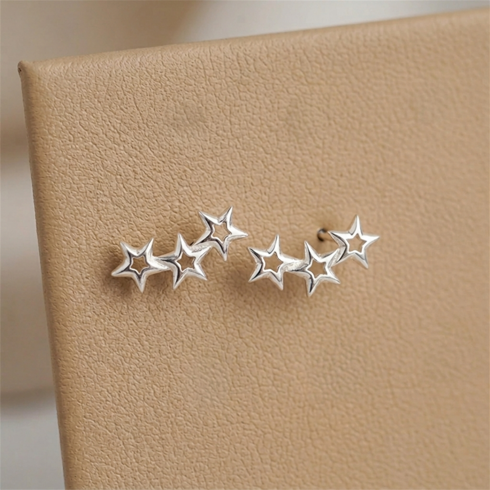Hollow star ear studs with linked star cluster, silver-tone finish