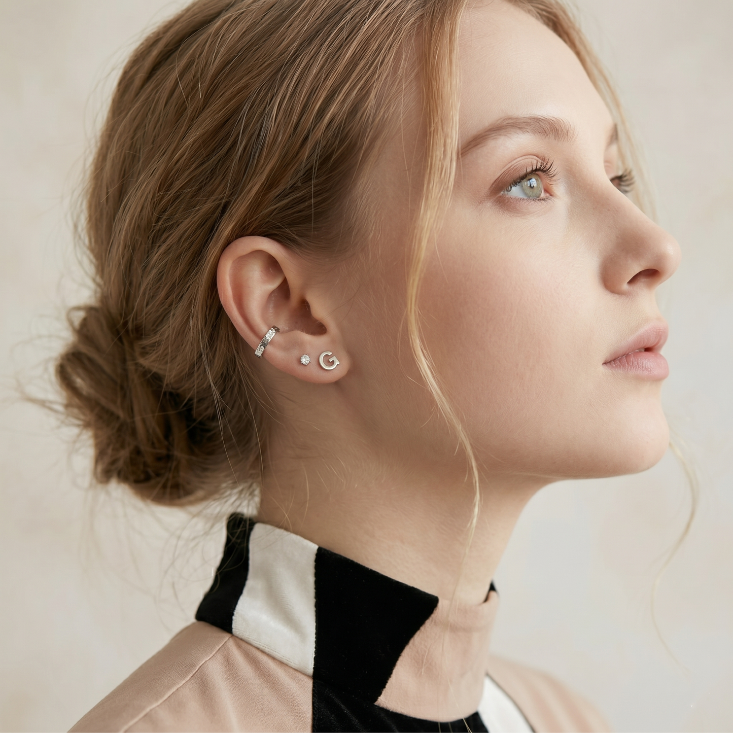 G initial stud earrings, silver-tone studs on the ear