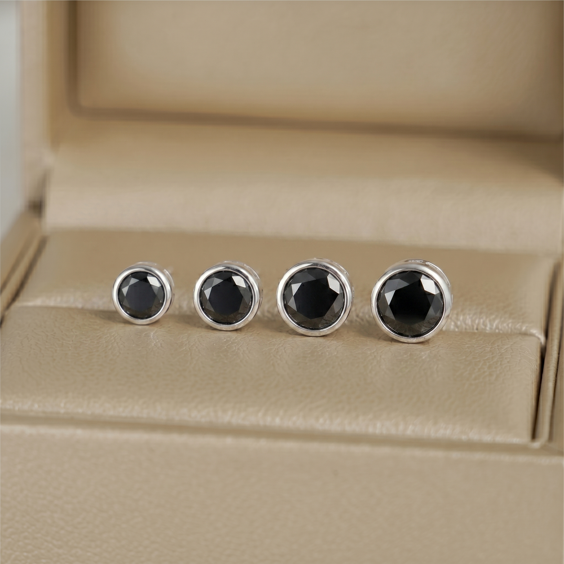 Bezel solitaire stud earrings, round black center stones in silver-tone bezels