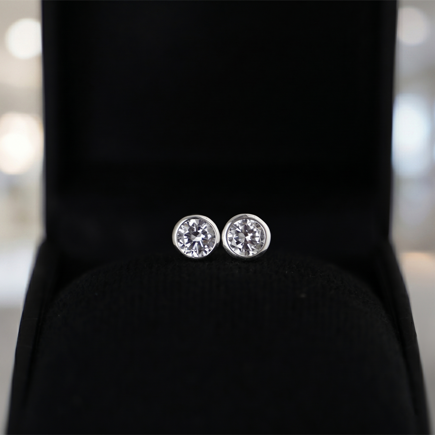 Clear bezel solitaire stud earrings, round faceted gemstone in silver-tone bezel