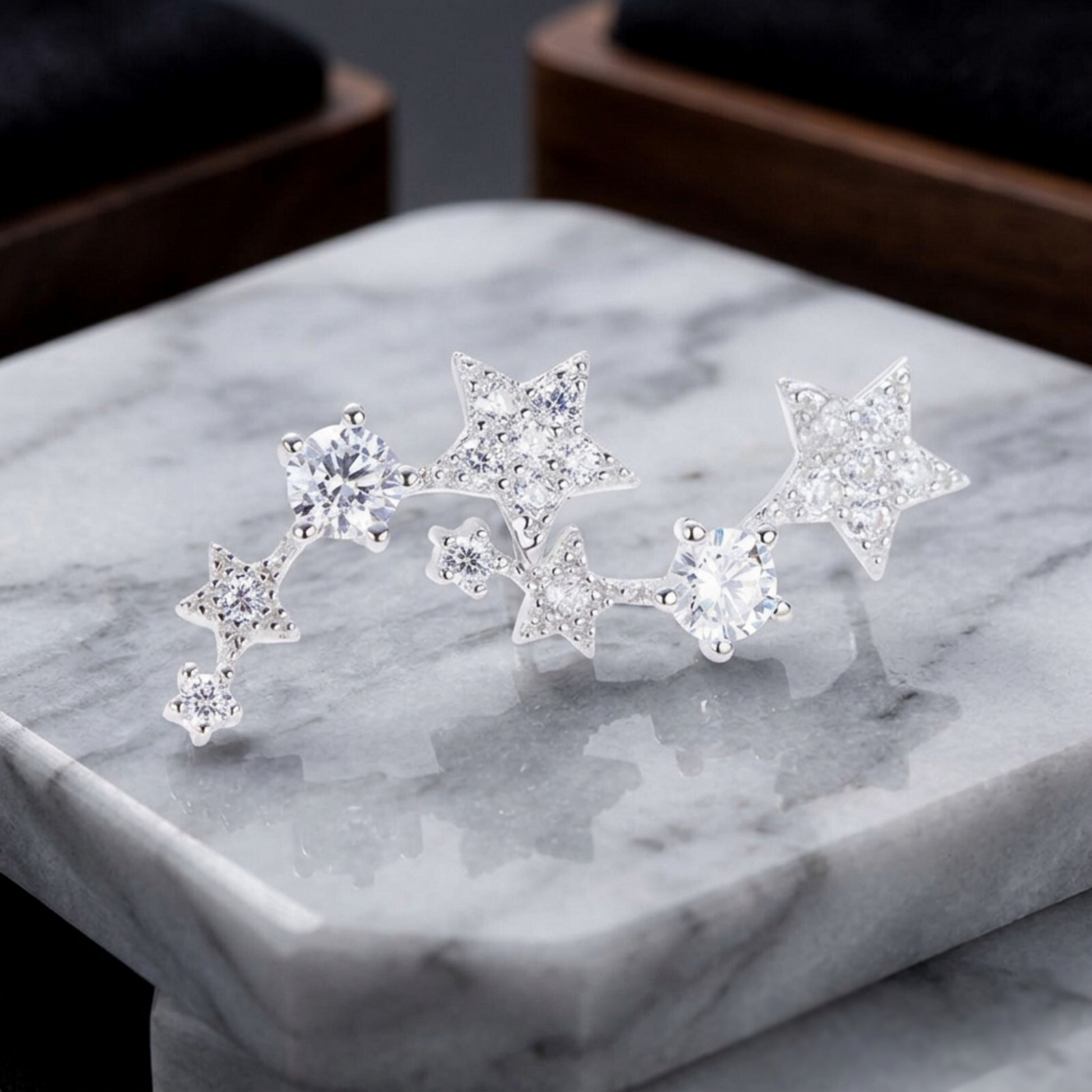 Pair of linked star CZ ear climbers on a jewelry box: three stars per earring