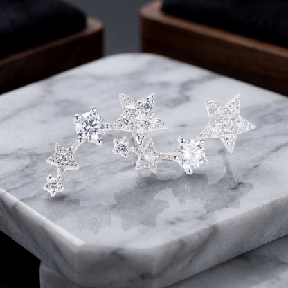 Pair of linked star CZ ear climbers on a jewelry box: three stars per earring