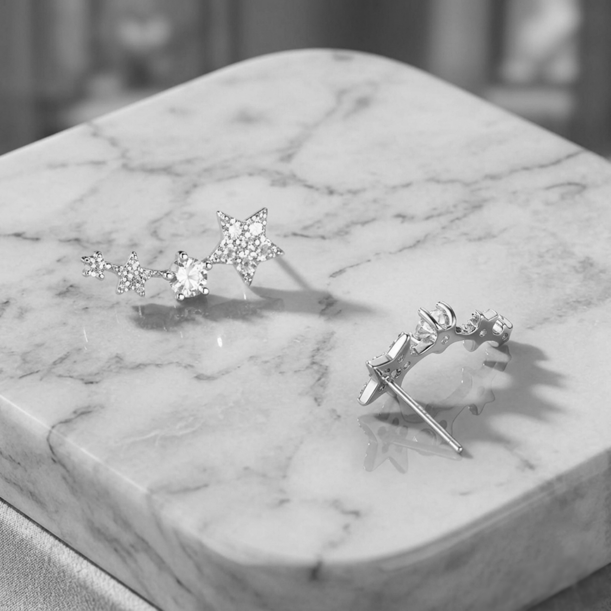 Linked star CZ ear climbers shown from the side: star drops with CZ centers