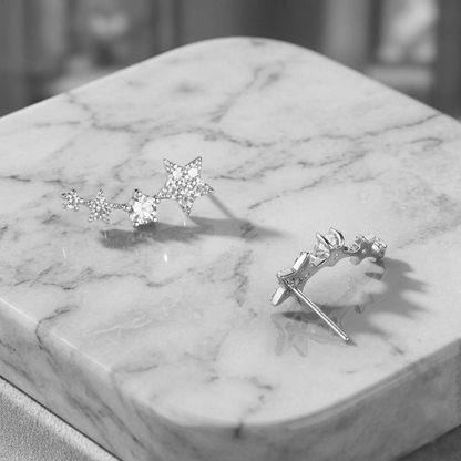 Linked star CZ ear climbers shown from the side: star drops with CZ centers
