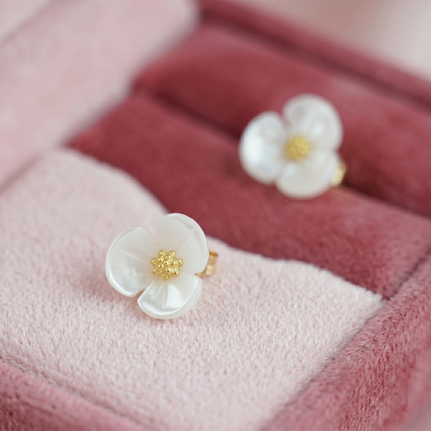 Mother of Pearl shamrock studs, white petals with gold center rosette, side view