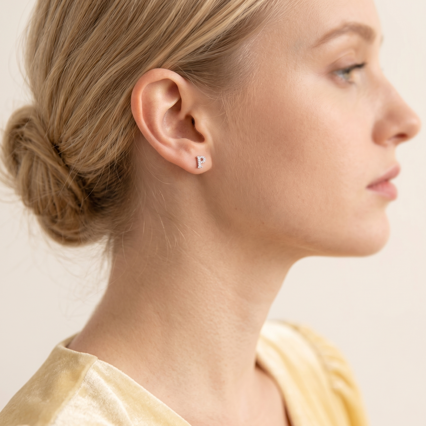 Mini CZ paved initial stud (P), silver-tone, worn on the ear