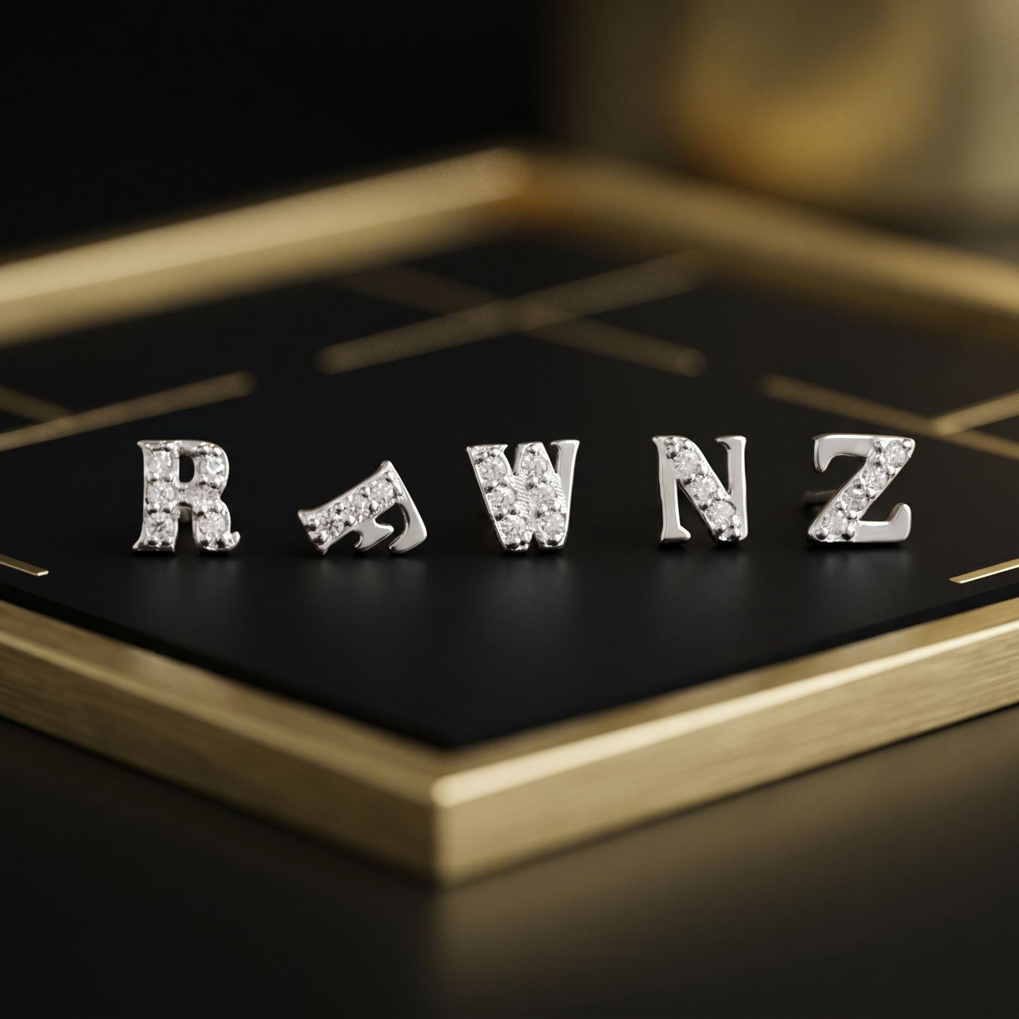 Mini CZ paved initial studs on tray—R, W, N, Z, silver-tone